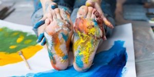 childs messy feet from painting with them